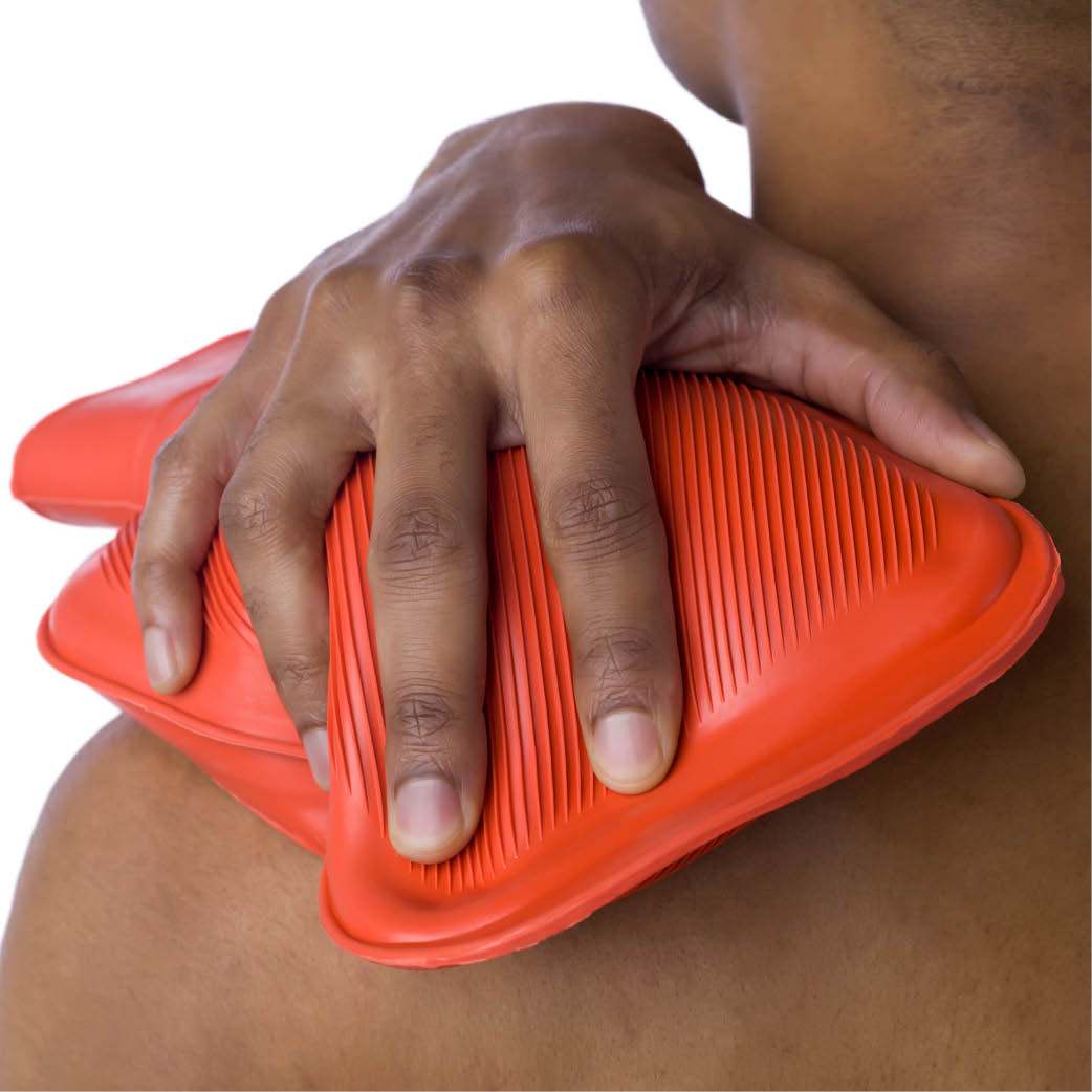 person in pain using heat pack